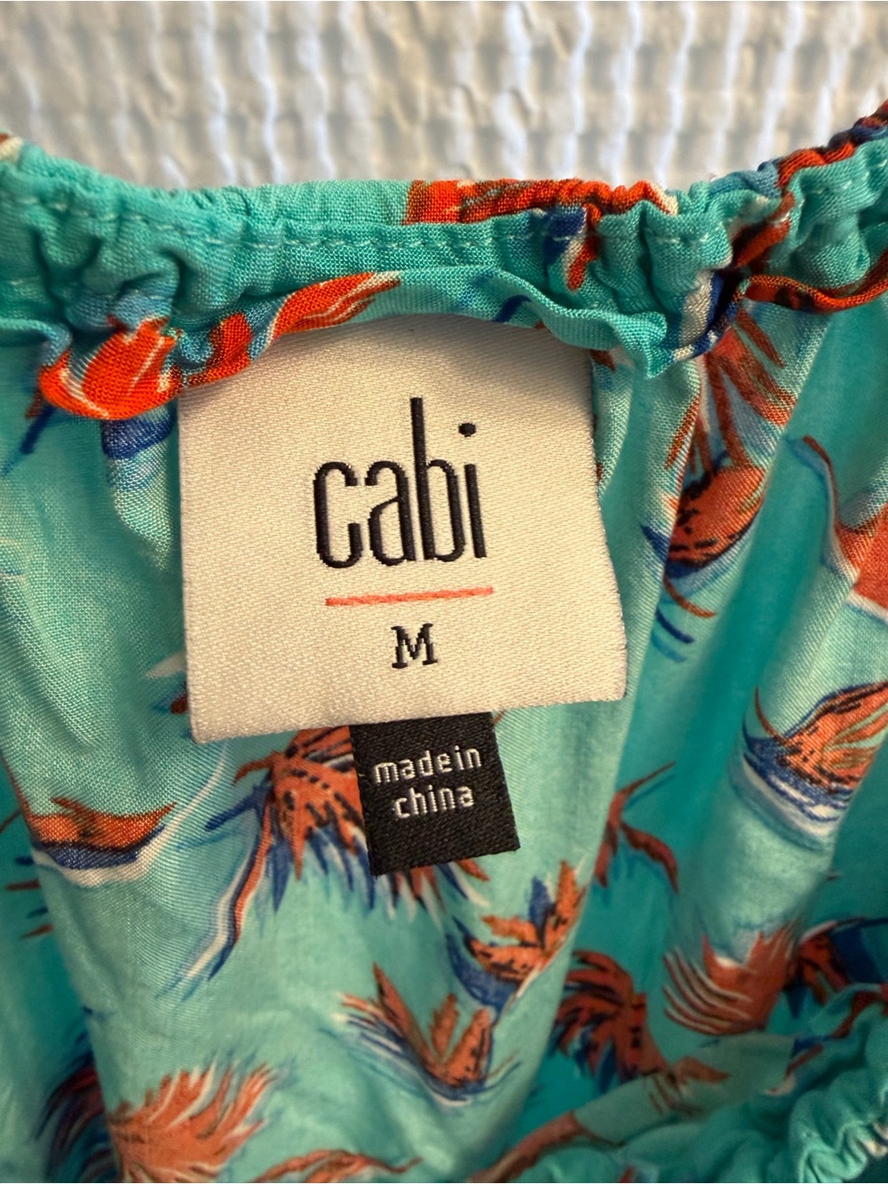 CAbi Turquoise Floral top with Orange & Navy Details